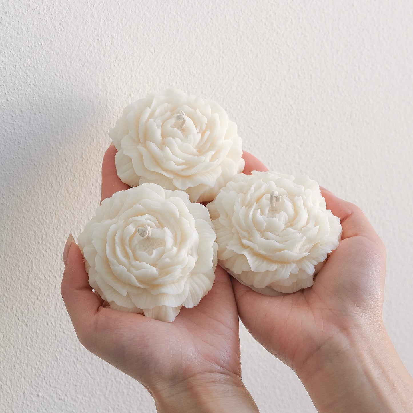 Three elegant lightly scented peony shaped soy wax candles. Candles have a fresh, floral scent, designed to elevate any space.